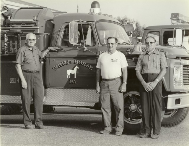 Late 1980's... (L to R) Chief Ross Parmer, Asst. Chief Mark Beyer, and Deputy Chief Elam Riehl pose in front of the 1967 Ford Pumper